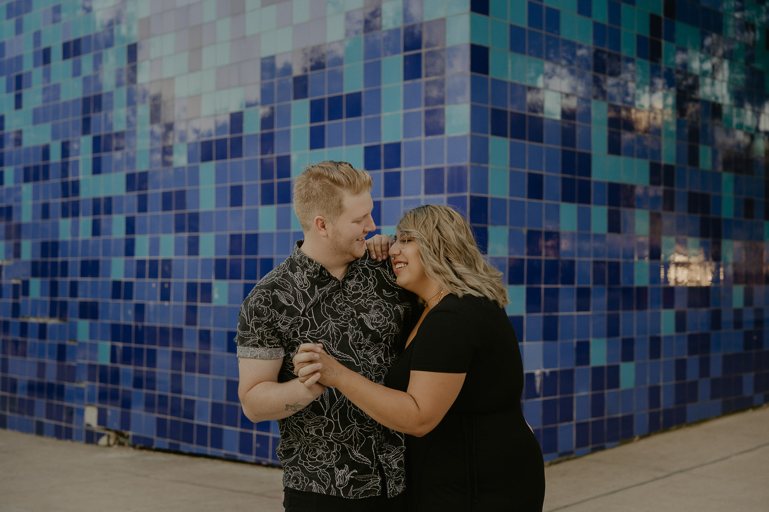 white-and-mexican-couple-austin-texas-engagement-couple-session-photos-blue-tile-wall-black-outfit-inspo
