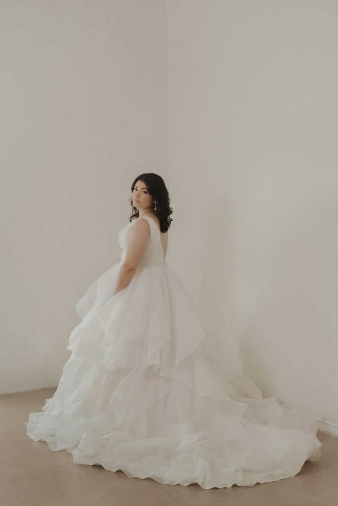 bride-wearing-white-layred-wedding-dress-in-white-studio-hair-down
